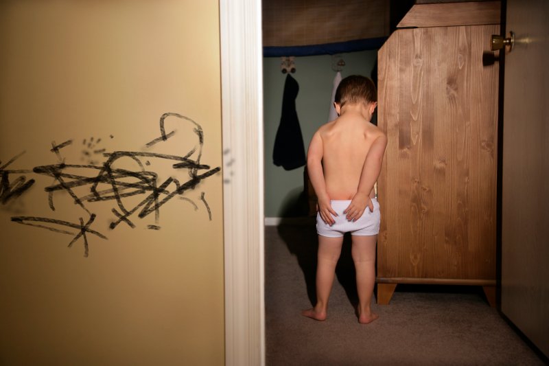 Little kid in Trouble After Drawing on the Wall