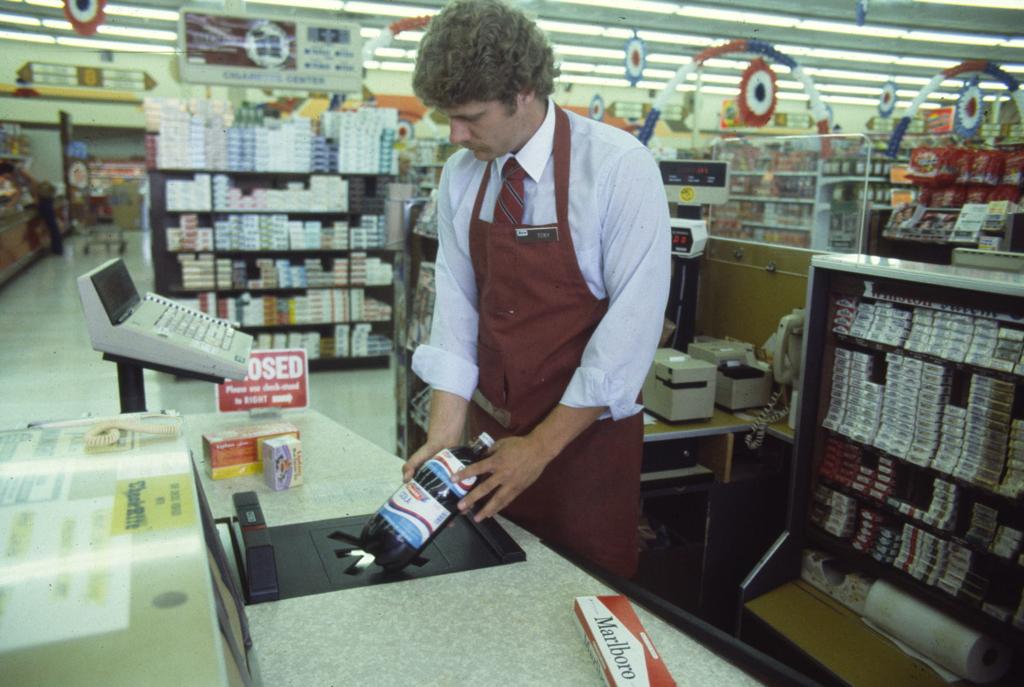 Man Ringing Up Products at Grocery Store